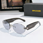 Sunglasses with black frame and light gray lenses, gold-tone details