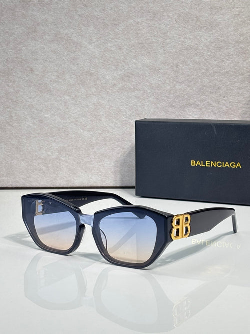 Sunglasses with dark blue frames, tinted lenses, and gold B emblem detail
