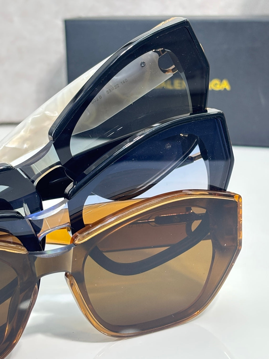 Sunglasses side view with tortoiseshell frame and gold B emblem hardware