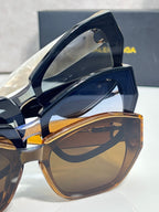 Sunglasses side view with tortoiseshell frame and gold B emblem hardware