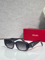 Prada sunglasses with black oversized frames and tinted lenses