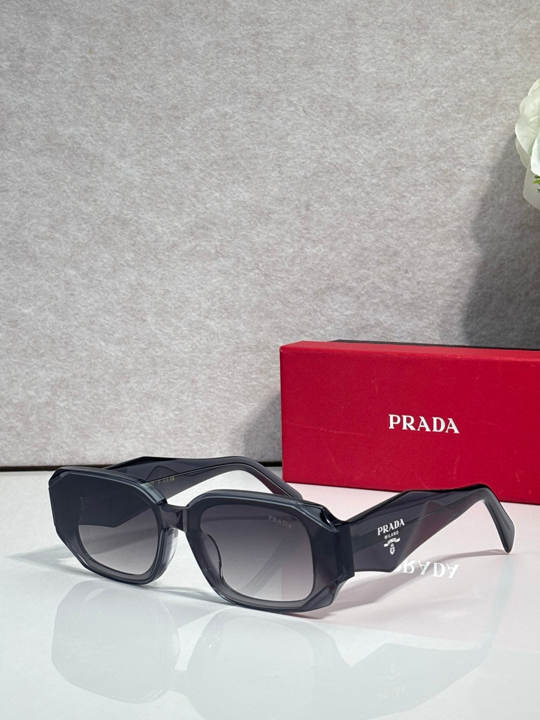 Prada sunglasses with black oversized frames and tinted lenses