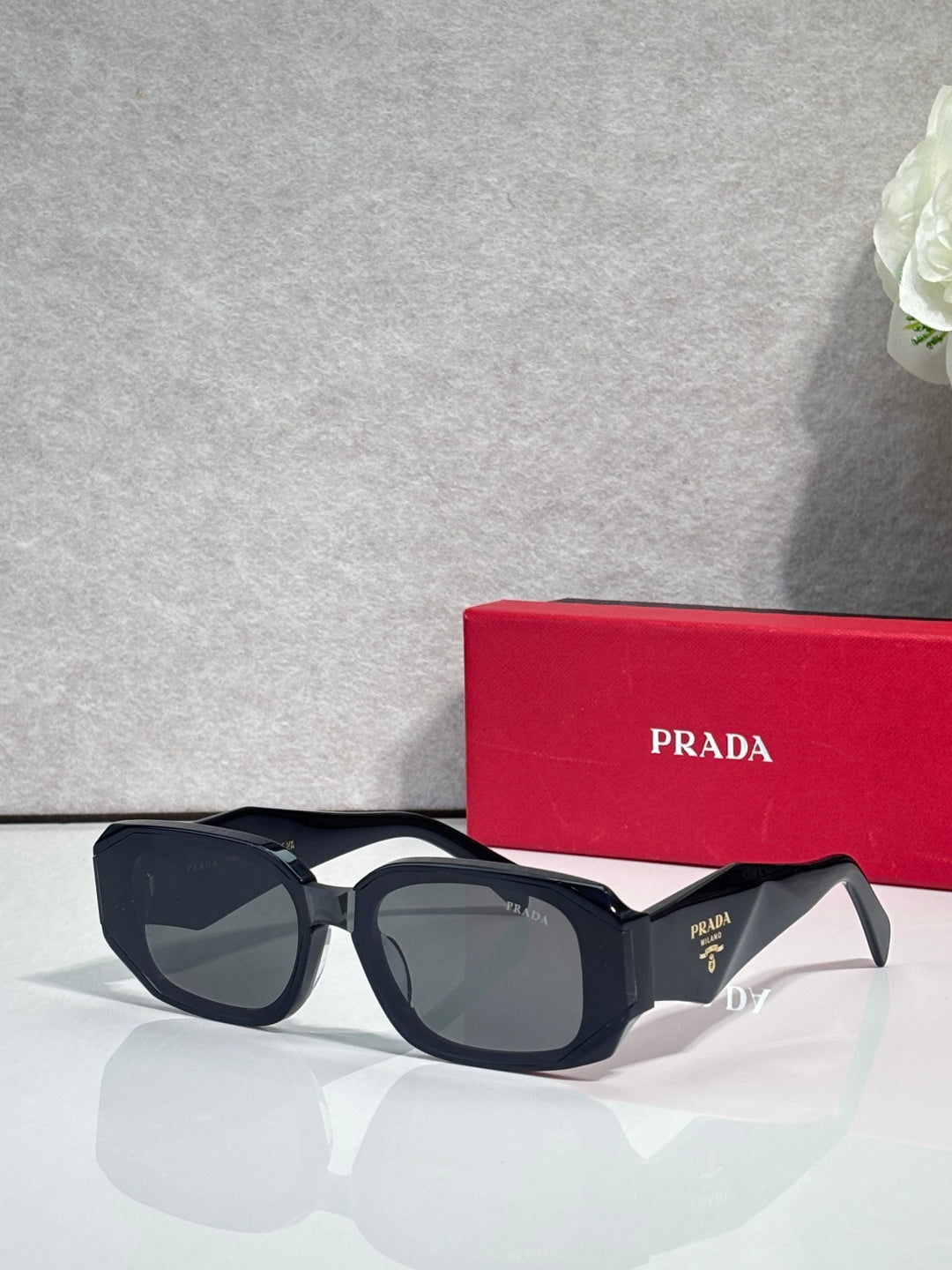 Prada sunglasses with dark navy oversized frames and tinted lenses