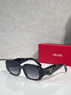 Prada sunglasses with dark navy oversized frames and tinted lenses