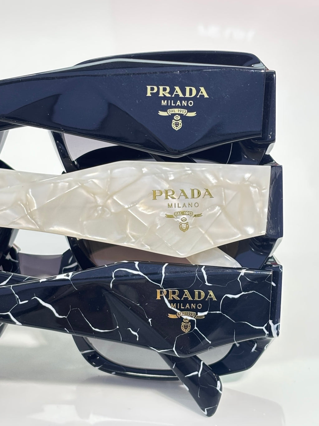 Prada sunglasses with patterned frames and included protective cases