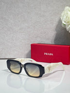 Prada sunglasses with dark navy oversized frames and tinted lenses