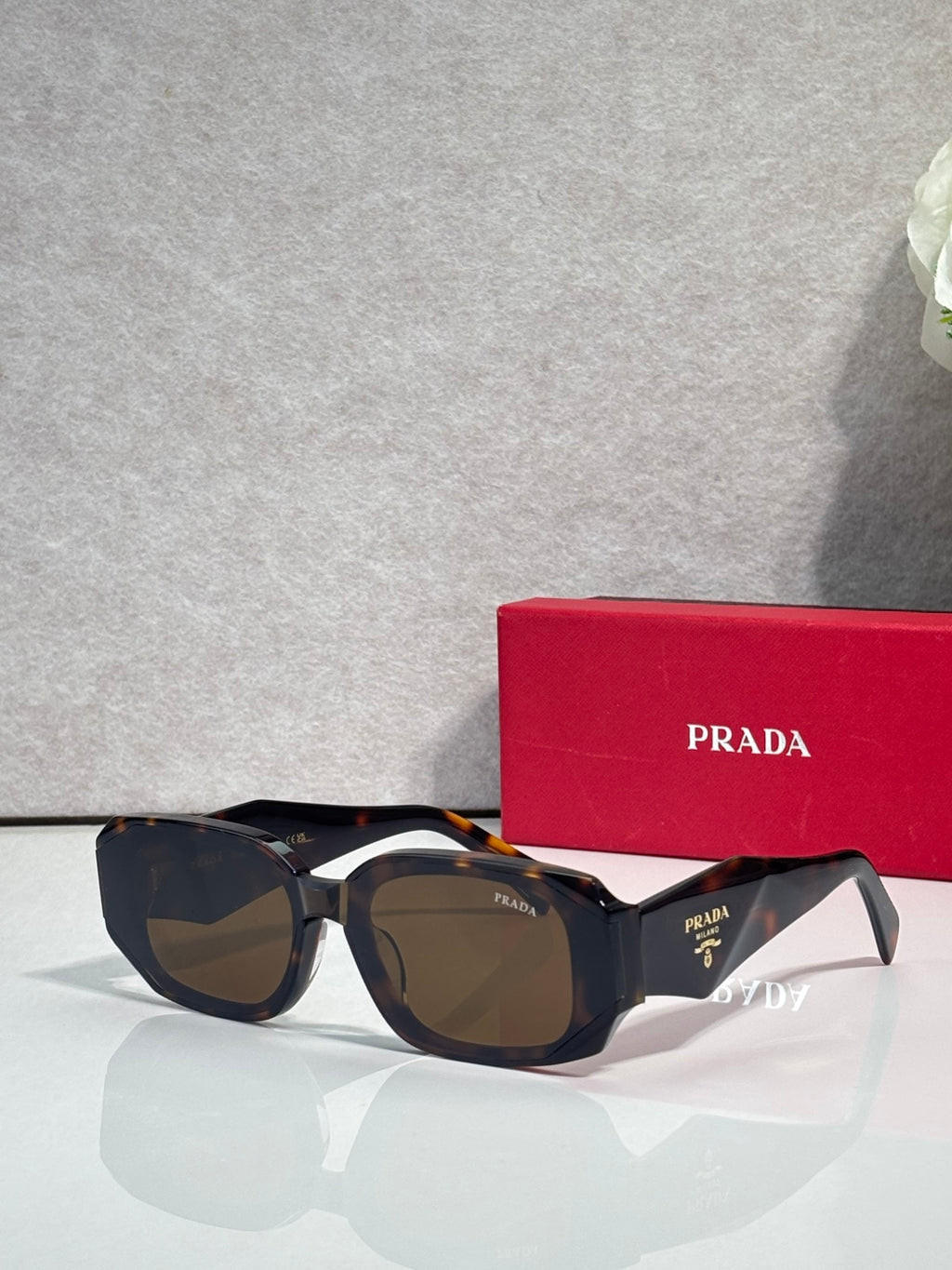 Prada sunglasses with dark oversized frames and tinted lenses