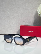 Prada sunglasses with dark navy oversized frames and tinted lenses