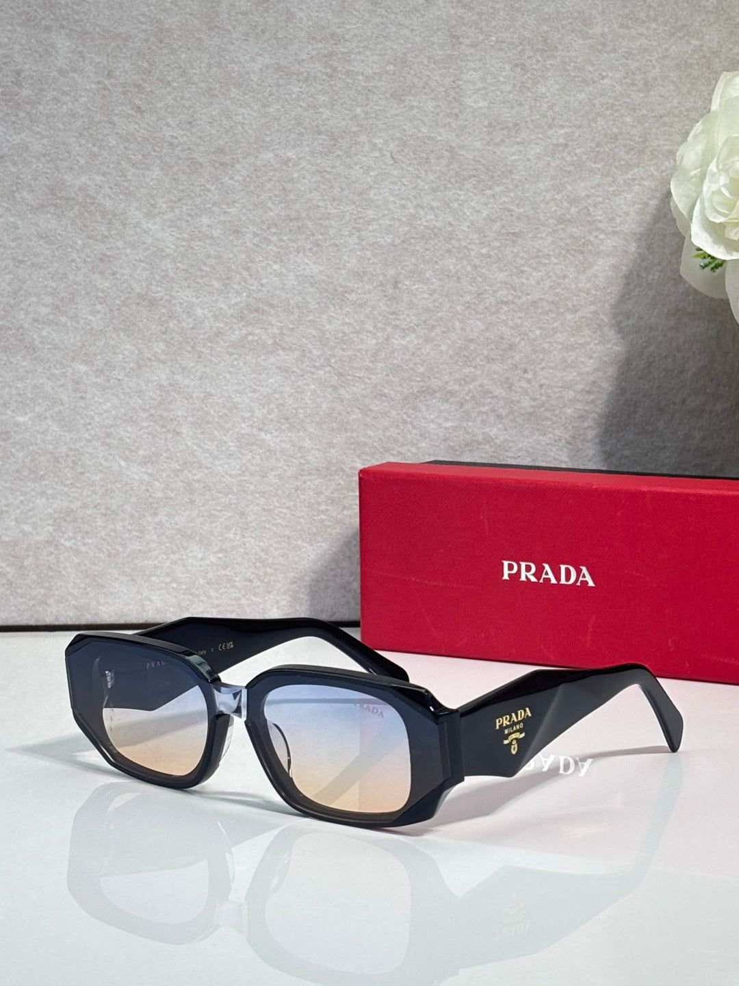 Prada sunglasses with dark navy oversized frames and tinted lenses