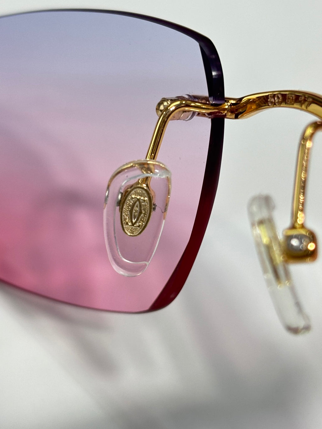 Cartier glasses frame detail with gold temple and dark lens