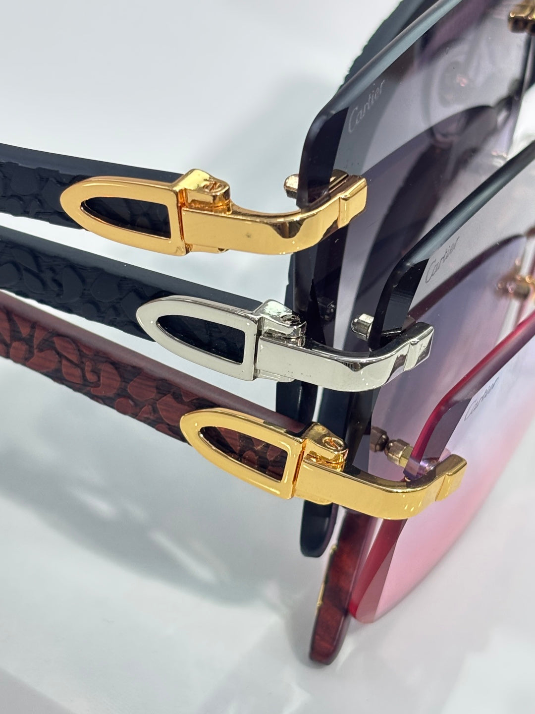 Cartier glasses temple detail with gold hardware on dark frames