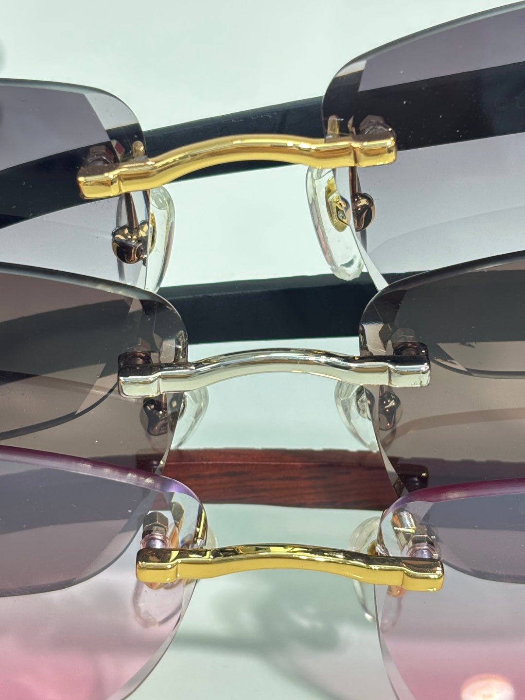 Cartier glasses close-up: gold metal bridge and temples with dark tinted lenses