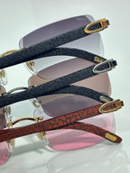 Cartier glasses close-up: textured dark temples with gold ends; pink-tinted lenses