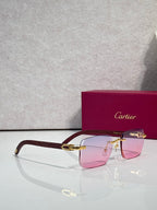 Cartier glasses with rectangular frames, burgundy temples, gold accents; pink-tinted lenses
