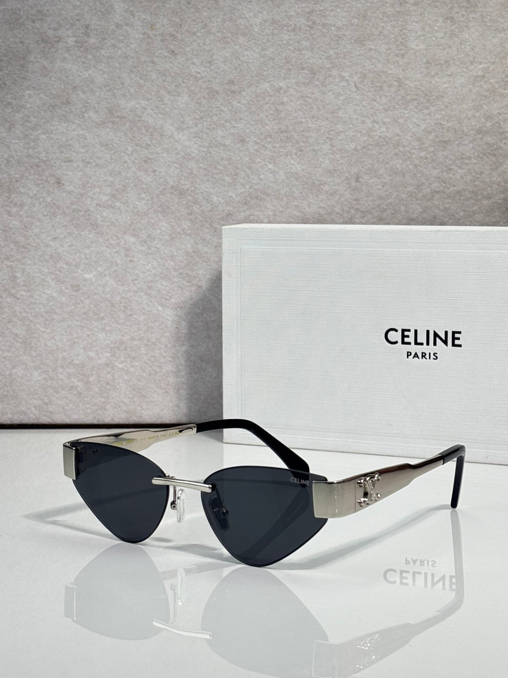 Celine glasses with gold frame, dark blue lenses, and tortoise top edges
