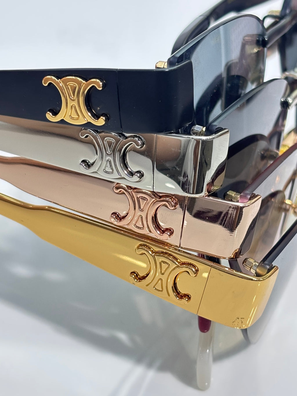 Celine glasses temple close-up with engraved Celine logos in gold and chrome