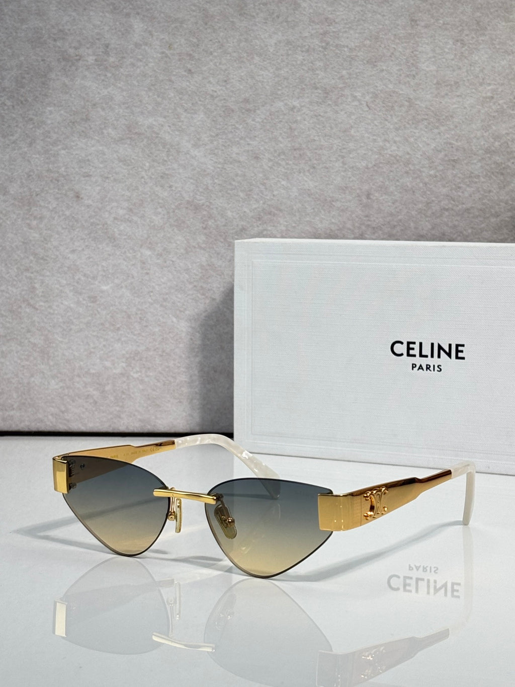 Celine glasses with gold frame, dark blue lenses, and tortoise temple details