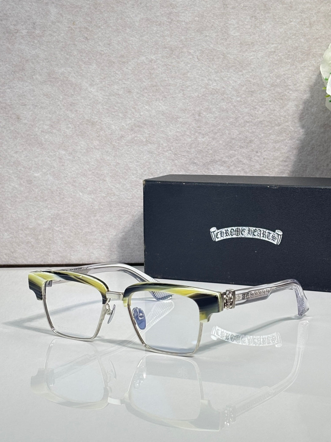 Eyeglass frames with square lenses, silver metal rim, and blue-tinted temple accents