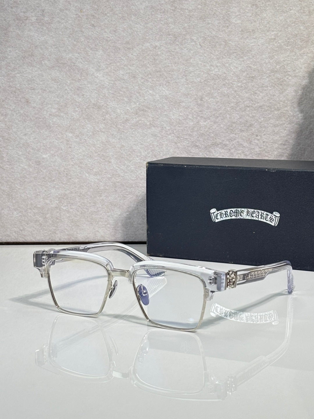Eyeglass frames with square clear lenses, silver metal rim, and rhinestone temple detail