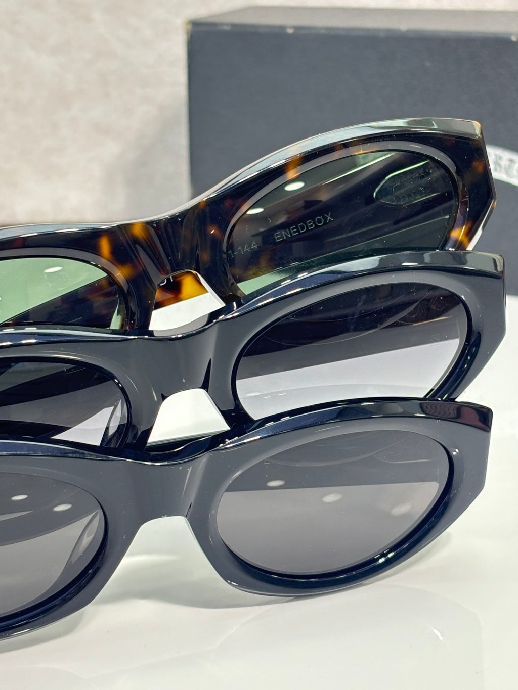 Close-up of cat-eye glasses frame with dark tortoiseshell top rim and tinted lens