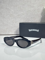 Cat-eye glasses with dark frame and tinted lenses, styled with metallic side hardware