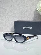 Cat-eye glasses side view with dark frame, tinted lenses, and gold-toned emblem detail