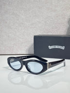 Cat-eye glasses with dark frame and tinted lenses, featuring a metallic side emblem