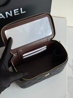 Quilted shoulder bag in black leather with flap open, showing card slot and interior pockets.