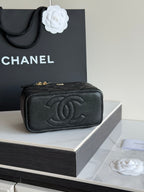 Quilted shoulder bag in black leather with embossed CC logo and gold hardware.