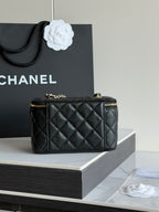 Quilted shoulder bag in black leather with top handle and gold hardware, CC emblem.