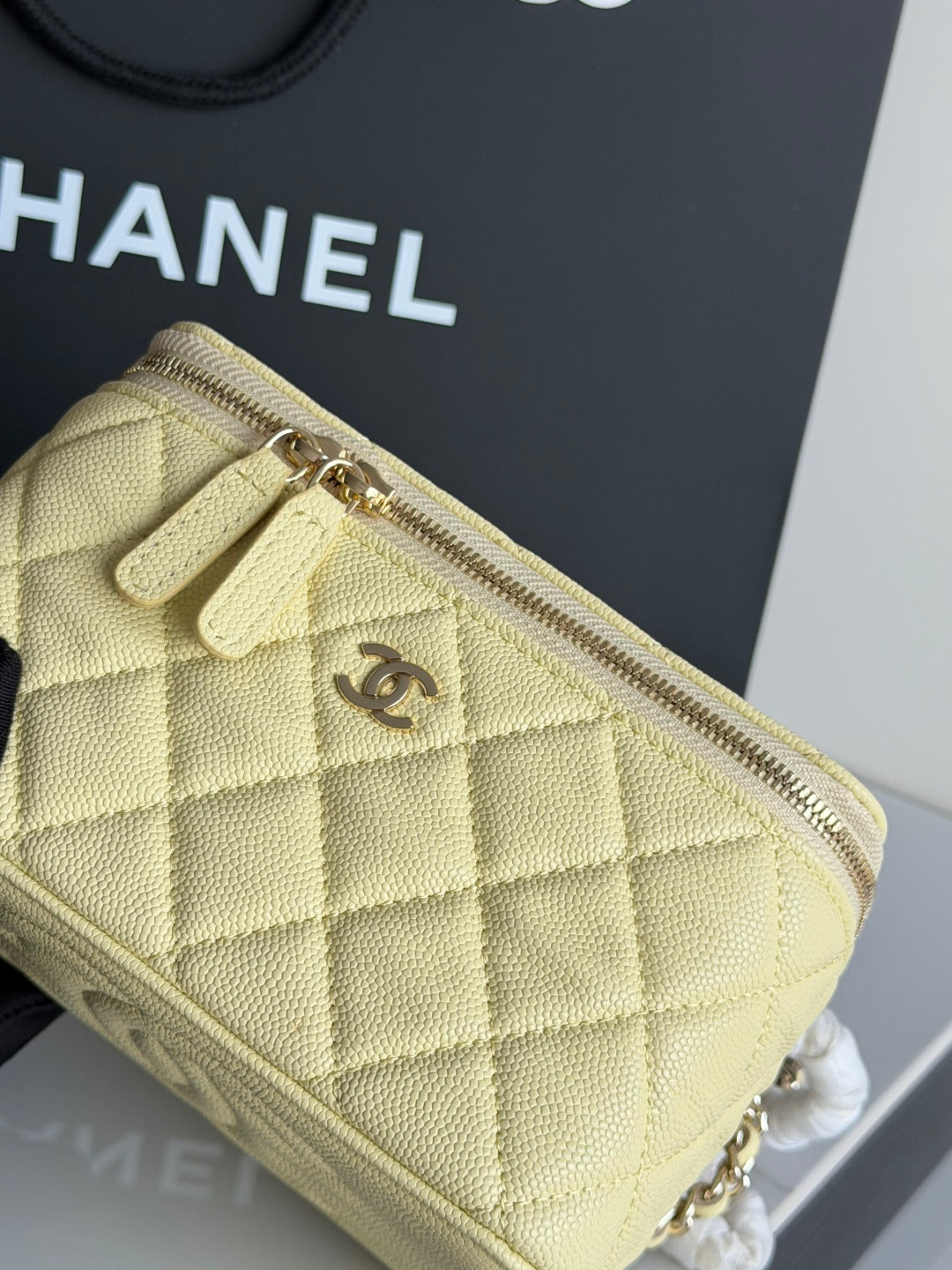 Chanel quilted mini crossbody bag pale yellow with gold zipper hardware and chain strap