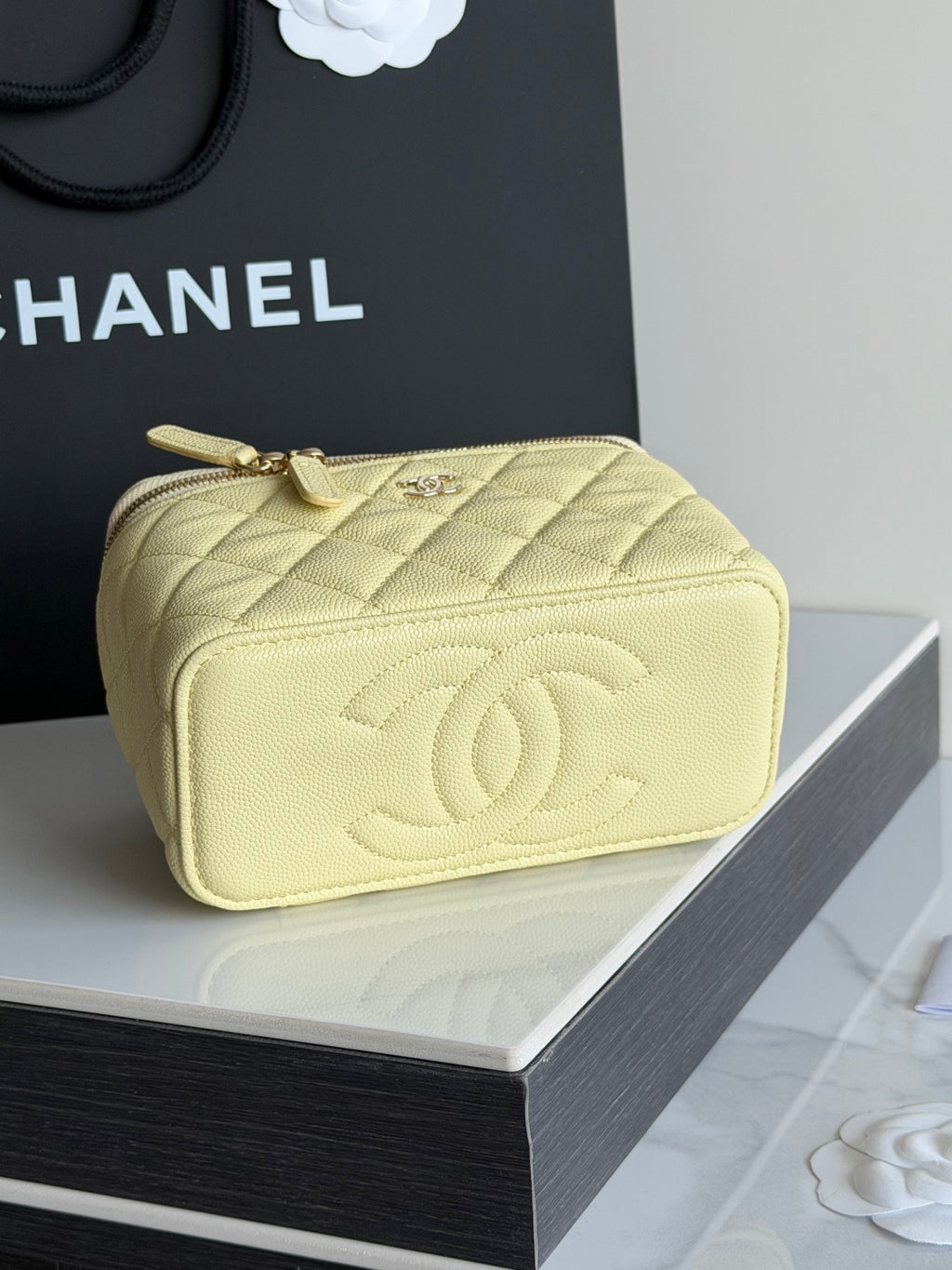 Chanel quilted mini crossbody bag in pale yellow with embossed CC logo and top zipper