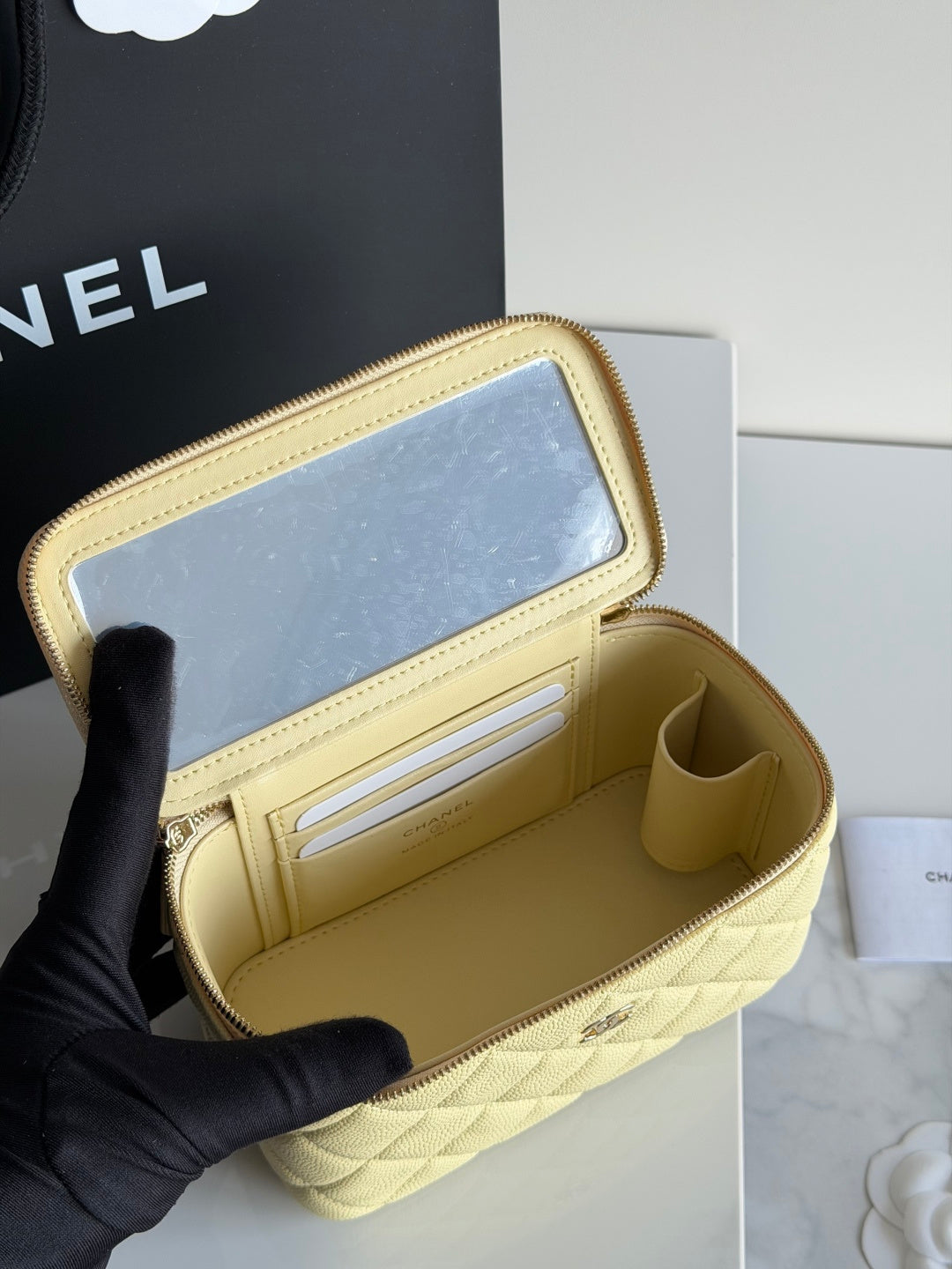 Chanel quilted mini crossbody bag in pale yellow, open interior showing card slots