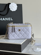 Light lavender quilted crossbody bag with gold chain strap and zipper top