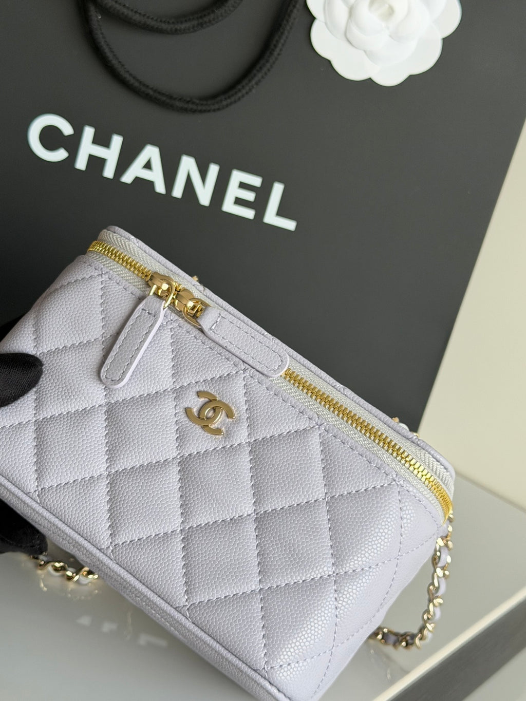 Light lavender quilted mini crossbody bag with front zip pocket and gold trim