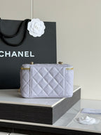 Light lavender quilted mini crossbody bag with gold hardware and top zipper