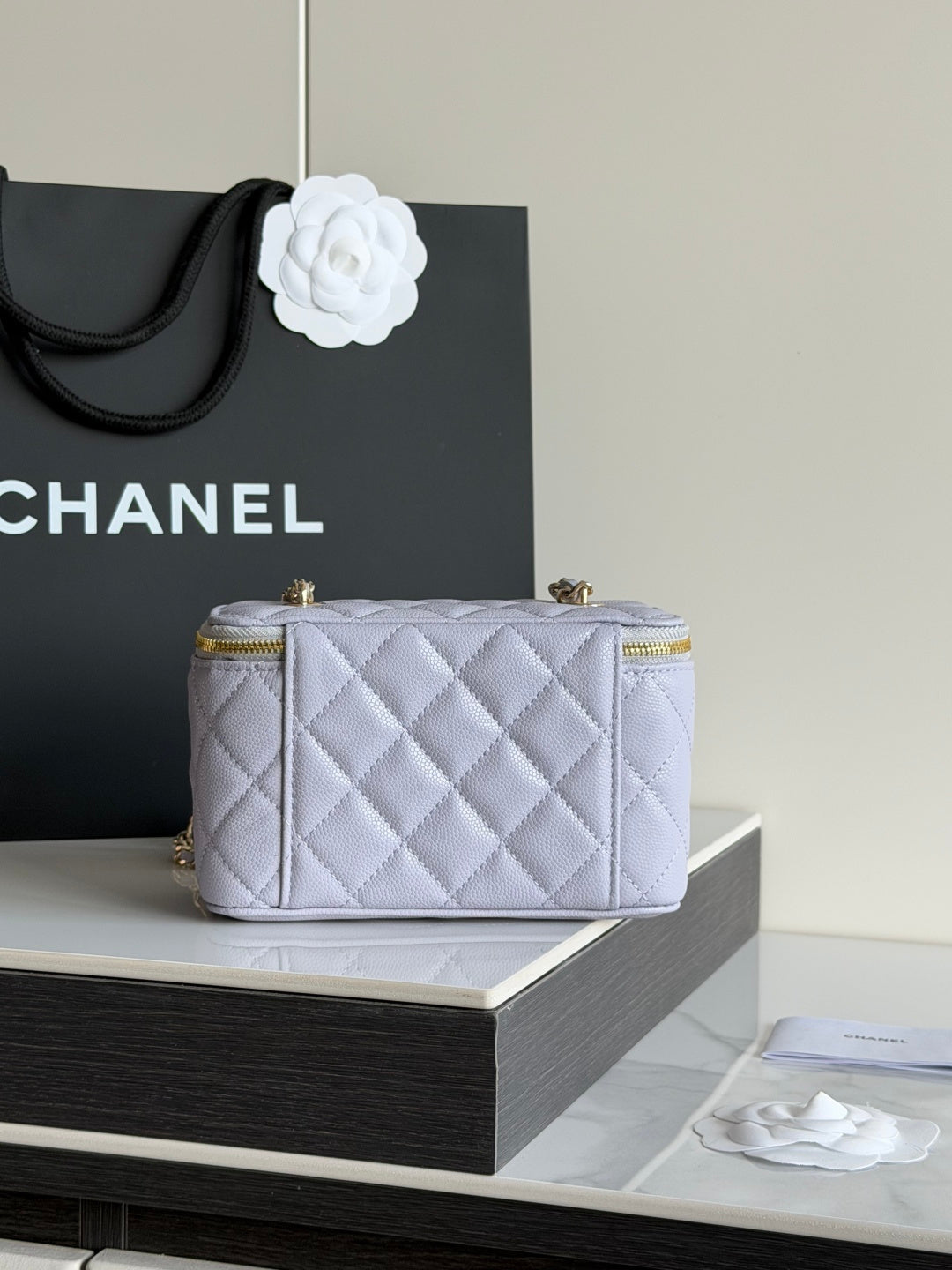 Light lavender quilted mini crossbody bag with gold hardware and top zipper
