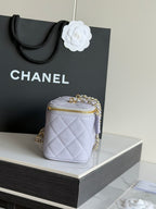 Light lavender quilted crossbody bag with gold chain strap and top handle
