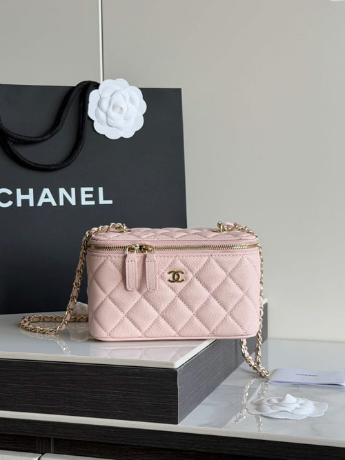 Quilted mini shoulder bag in pale pink with gold chain and top zip closure.