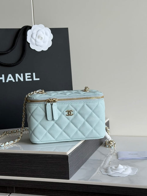 Chanel light blue quilted mini bag with gold zipper, top handles, and chain strap