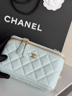 Chanel quilted light blue mini bag close-up of gold zipper and CC logo