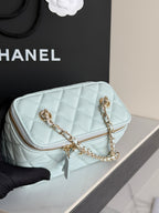 Chanel light blue quilted mini bag close-up with gold chain strap and zipper pocket
