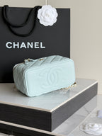 Chanel light blue mini bag with quilted texture, gold chain strap, and embossed CC