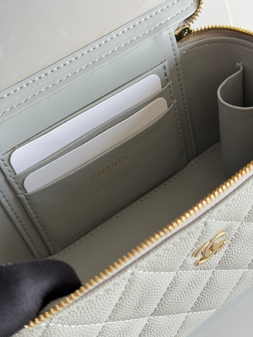Inside view of Chanel quilted mini wallet bag with card slots and zipper pocket.