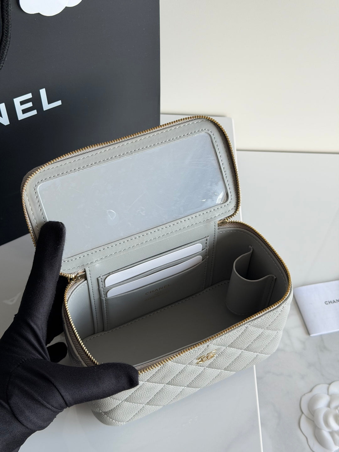 Open quilted Chanel mini wallet bag with card slots and fabric-lined interior.