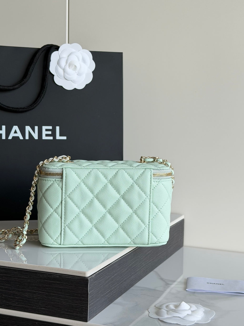 Mint quilted crossbody bag with top zip closure and gold-tone logo emblem