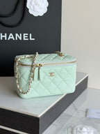 Mint quilted small bag with top zip, chain strap, and gold-tone emblem center