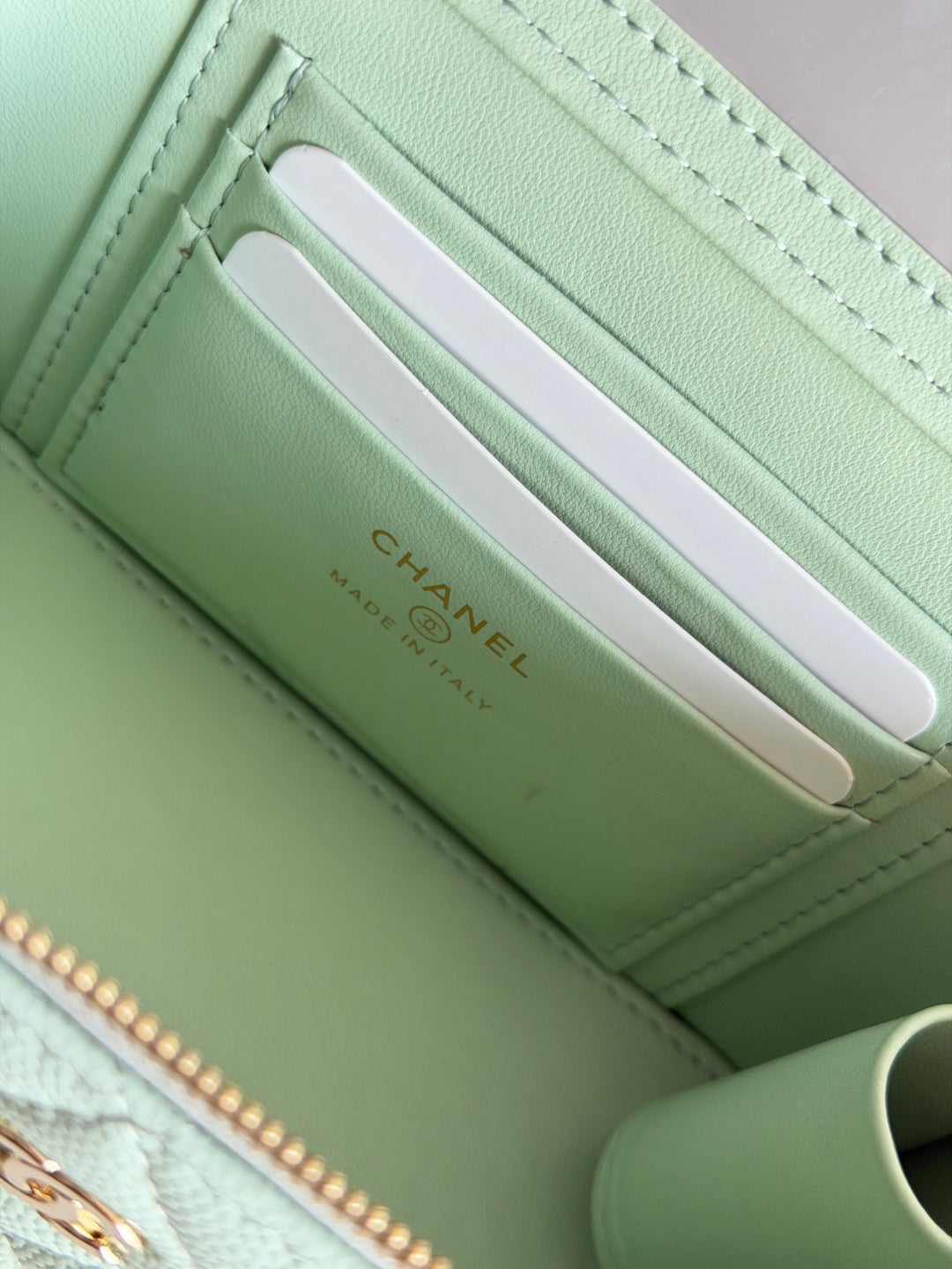 Mint green Chanel card holder pocket with logo, zip-top compartment and slot windows