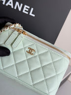 Mint quilted bag close-up with top zipper, CC emblem, and gold chain hardware