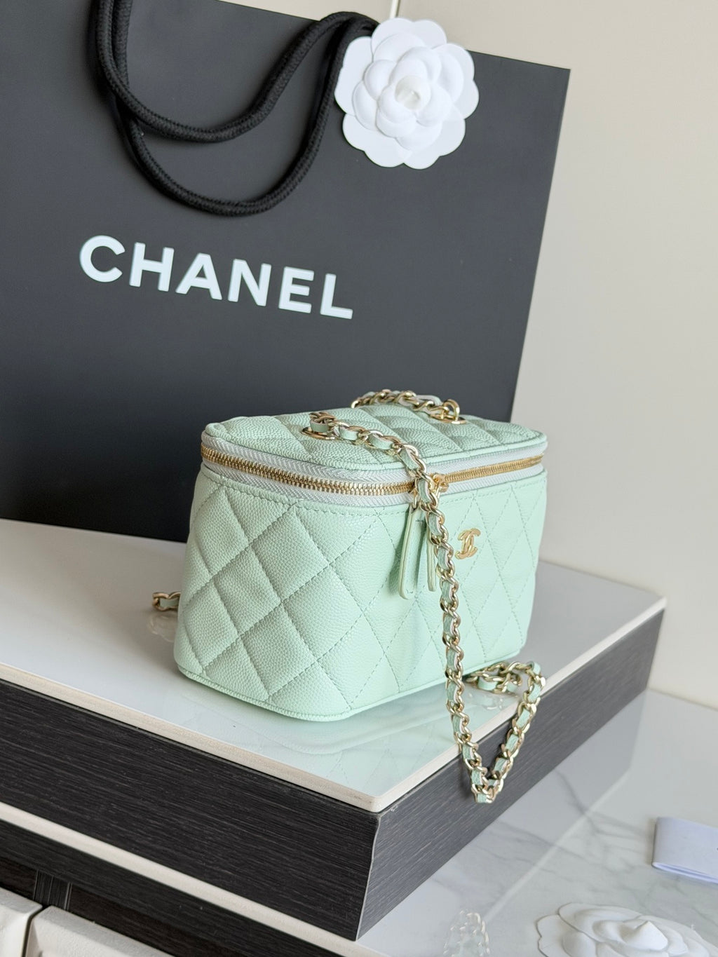Mint quilted small shoulder bag with top zip and long chain strap